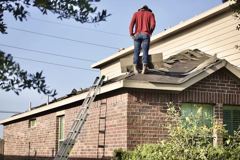 Professional roofer working on a residential roof in Erie